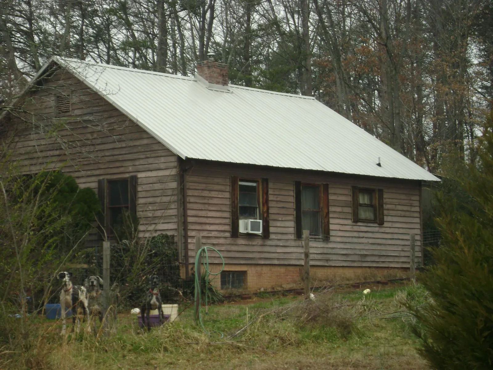 White metal roof on an old wood sided farmhouse, from a Metal Roof Installation job in Northridge