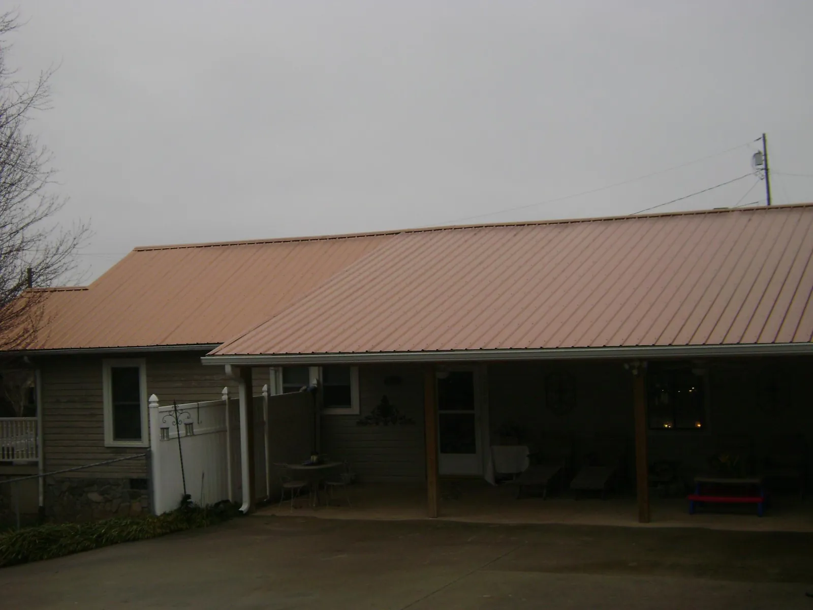 Copper toned metal roof over a wide covered patio in Northridge